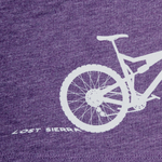 Close up of purple mountain bike tee.  "Lost Sierra" appears to be written in the tread marks left by the bike tire.